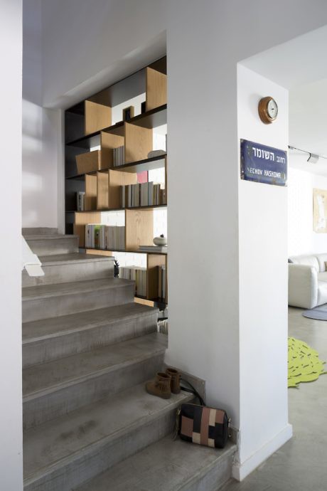 Contemporary staircase with unique geometric bookshelf design.