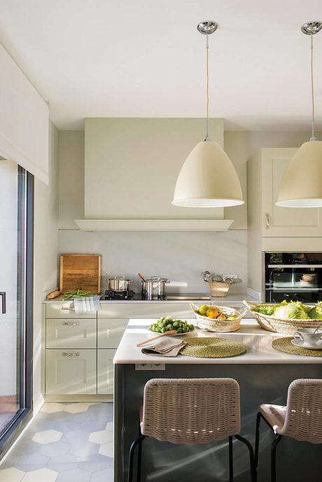 Contemporary kitchen with sleek white cabinets and pendant lighting.