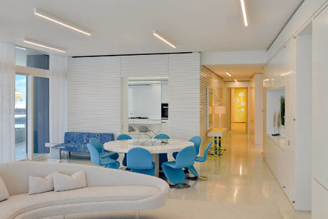 Contemporary living space with sleek furniture and bright lighting.