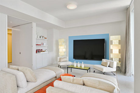 Contemporary living room with neutral tones and accent lighting.