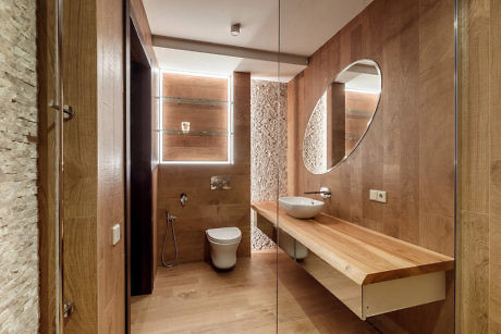 Modern bathroom interior with wooden finishes and a glass partition.