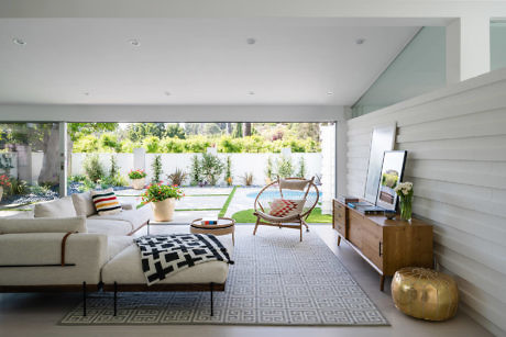 Contemporary living room with sliding doors opening to garden.