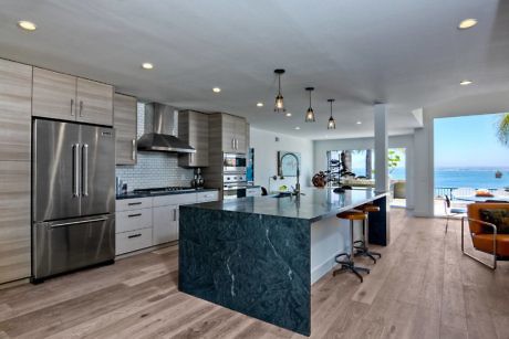 Modern kitchen interior with island and ocean view.