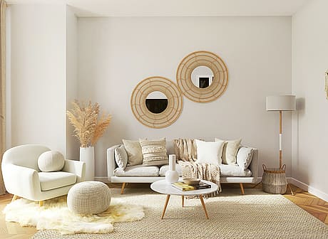 Beautifully designed living room with beige sofas, round mirrors, and bohemian decor.