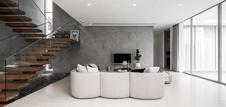 Modern living room with minimalist design, floating staircase, and neutral colors.