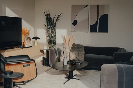 Contemporary living room with minimalist decor and abstract wall art.