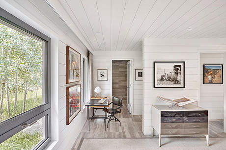Bright, contemporary hallway with art displayed on white walls.