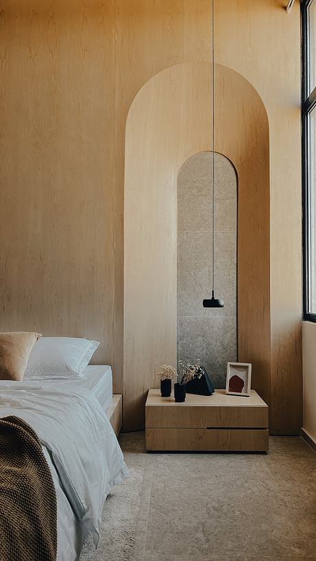 Minimalist bedroom with arched recess and pendant light