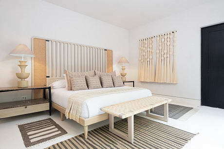 Contemporary bedroom with neutral tones and textured accents.