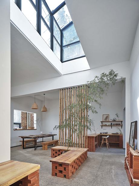 Modern dining area with skylight, brick accents, and wooden furniture.