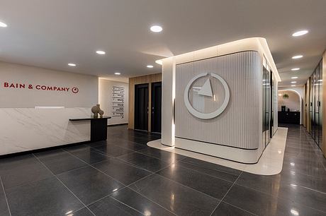 A modern, sleek lobby with a minimalist reception desk and architectural details.
