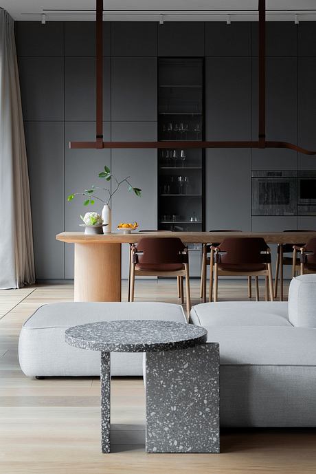 Sleek, minimalist kitchen and dining space with dark cabinetry and wooden accents.