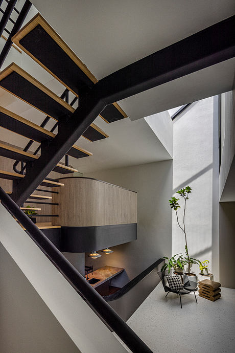 Stylish geometric staircase with wooden shelves and potted plant add visual interest.