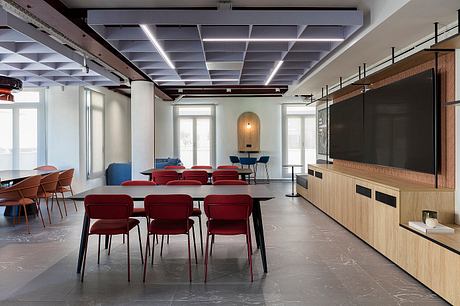Large open-plan office space with modern lighting, tiled flooring, and custom furniture.