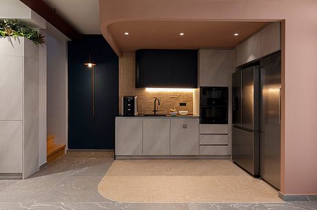 Sleek modern kitchen with black cabinetry, stainless steel appliances, and patterned tile floor.