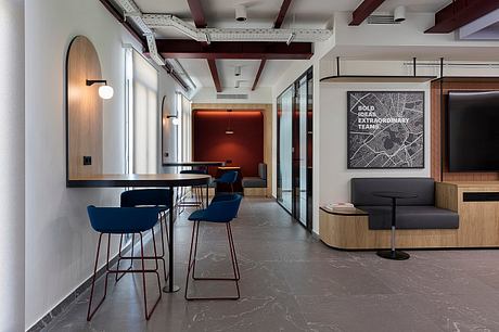 A modern, open-concept office space with bold geometric patterns, wood accents, and sleek furniture.