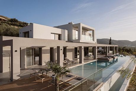 Striking modern villa with sleek architecture, expansive pool, and lush landscaping.