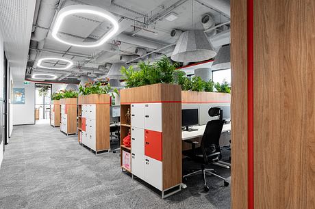 A modern office space with sleek furniture, lush greenery, and a clean, minimalist aesthetic.