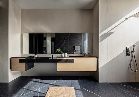 Sleek, modern bathroom with floating wood and black stone vanity, large mirror.