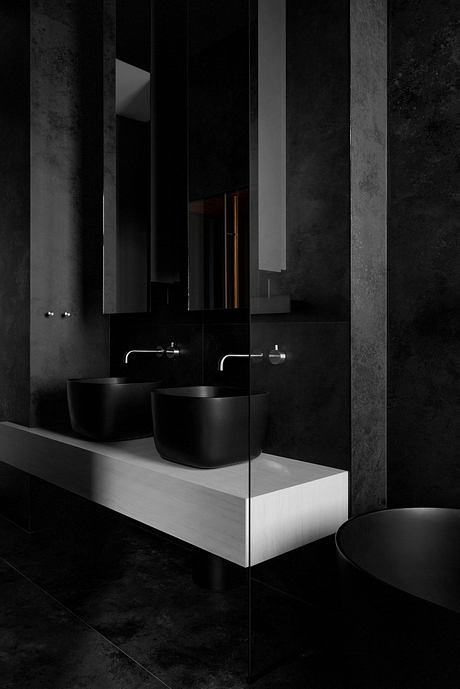 Sleek, minimalist bathroom design with black fixtures, mirrors, and a floating vanity.