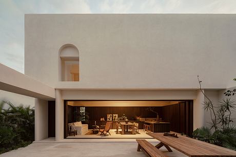 Warm-toned, modern architectural structure with an open, inviting indoor-outdoor design.