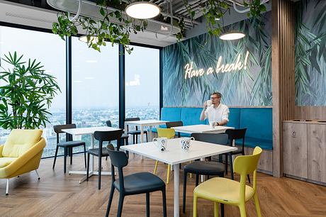Vibrant, nature-inspired office space with tropical accents, modern furnishings, and scenic views.