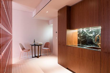 Tranquil dining nook with wood paneling, marble backsplash, and copper fixtures.