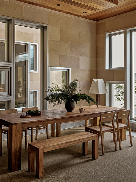 Inviting rustic dining space with wooden furniture, stone walls, and natural accents.