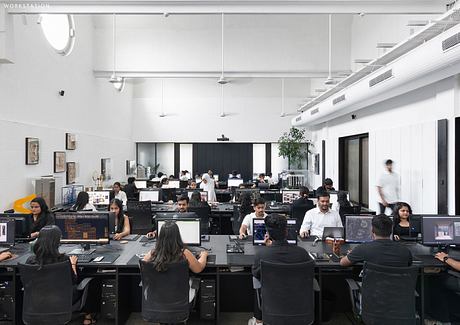 Spacious open-concept office with industrial chic decor and modern workstations.