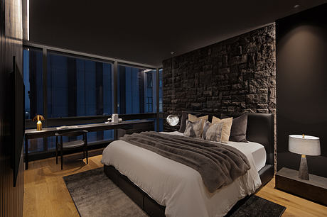 Cozy dark-themed bedroom with stone wall, wooden floors, and modern furnishings.