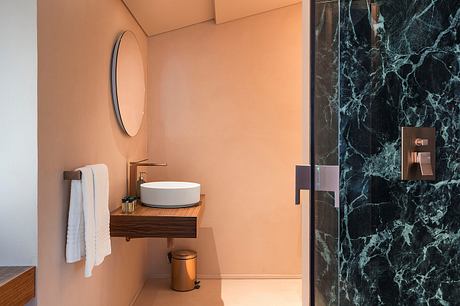 Luxurious bathroom with warm tones, sleek vanity, and striking black marble wall.