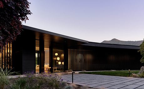 Modern architectural design with sleek lines, wood accents, and landscaped gardens.