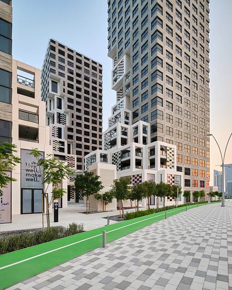 Modern urban architecture with diverse patterns, textures, and greenery around a paved walkway.