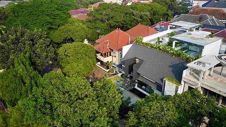 Lush greenery surrounds a residential complex with varied architectural styles.