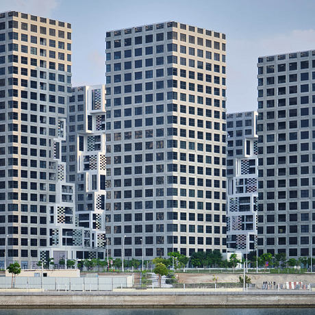 A striking modern architecture with geometric patterns and contrasting colors on the building facades.