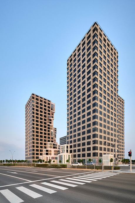 Distinctive modern high-rise buildings with geometric patterns and crossing paths below.