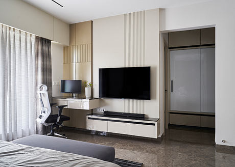Modern bedroom interior with sleek furniture, wall panels, and TV console. Minimalist design.
