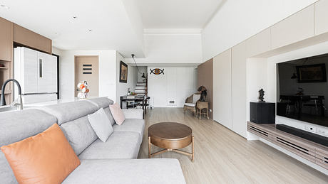 Bright, modern living room with neutral tones, geometric decor, and sleek furnishings.
