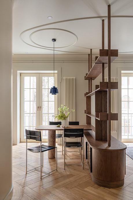 Sophisticated interior with arched ceiling, wooden shelving, and modern dining set.