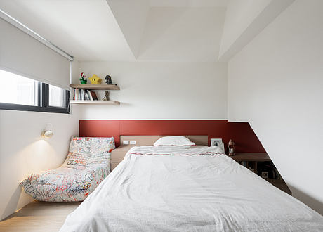 Sleek, modern bedroom design with minimalist shelving, vibrant accent wall, and cozy furnishings.