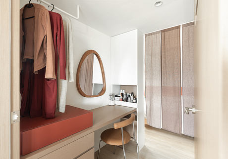 Light-filled room with modern minimalist furniture, storage, and wall-mounted mirror.