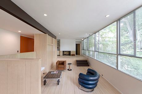 Sleek, modern living space with floor-to-ceiling windows and minimalist furnishings.
