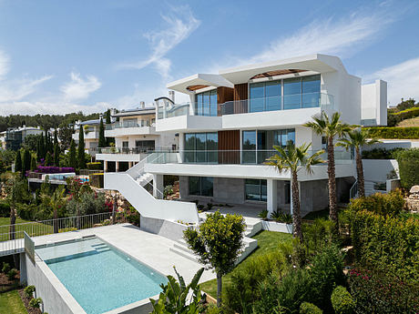 A stunning modern villa with sleek architecture, expansive balconies, and a beautiful pool.
