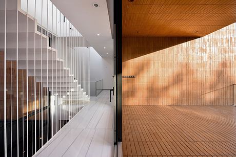 Elegant modern corridor with sleek partitions and warm wooden accents.
