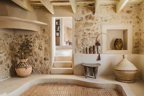 Rustic stone walls, beamed ceilings, and earthy decor elements create a warm, inviting atmosphere.