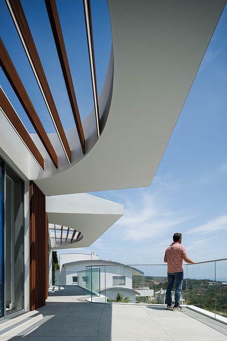 Striking architectural design featuring geometric patterns, glass walls, and an outdoor terrace.