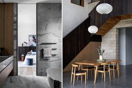 A modern, minimalist interior with wooden furniture, stone walls, and pendant lighting.