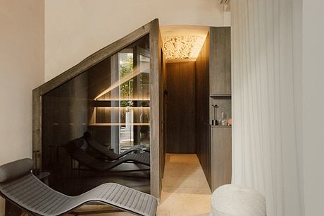A modern, open-concept interior with geometric lighting and angled architectural details.