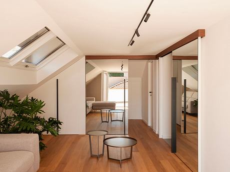 Bright, airy space with skylights, wooden beams, and modern furniture in a cozy living area.