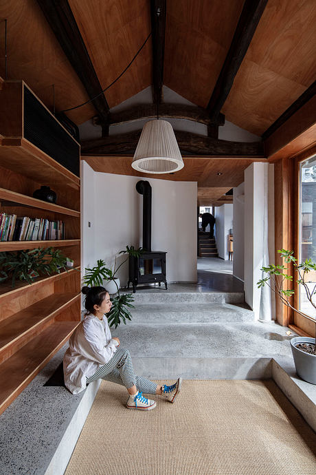 Warm, cozy wooden interiors with a modern fireplace and geometric stairs. Stylish atmosphere.
